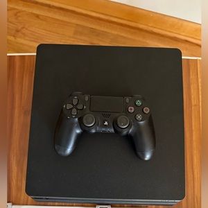 Ps4 slim 1tb console with power cord, HDMI cable, and one controller.